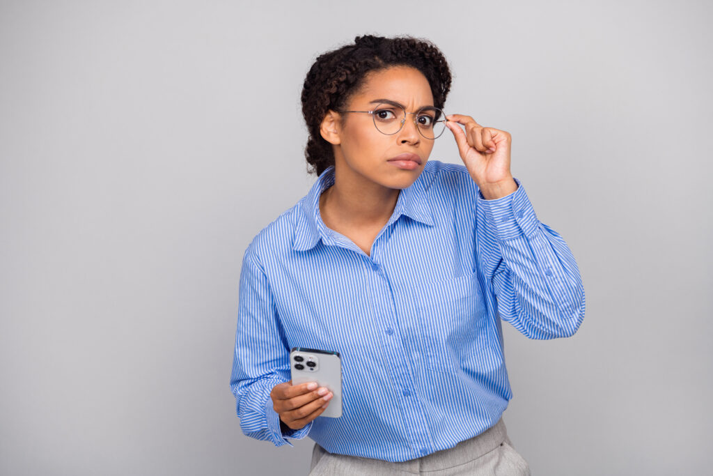 Photo portrait of lovely business lady stressed amazed hold device dressed stylish formalwear isolated on gray color background.
