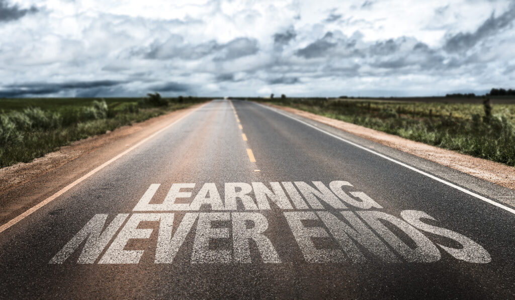 Learning Never Ends written on rural road