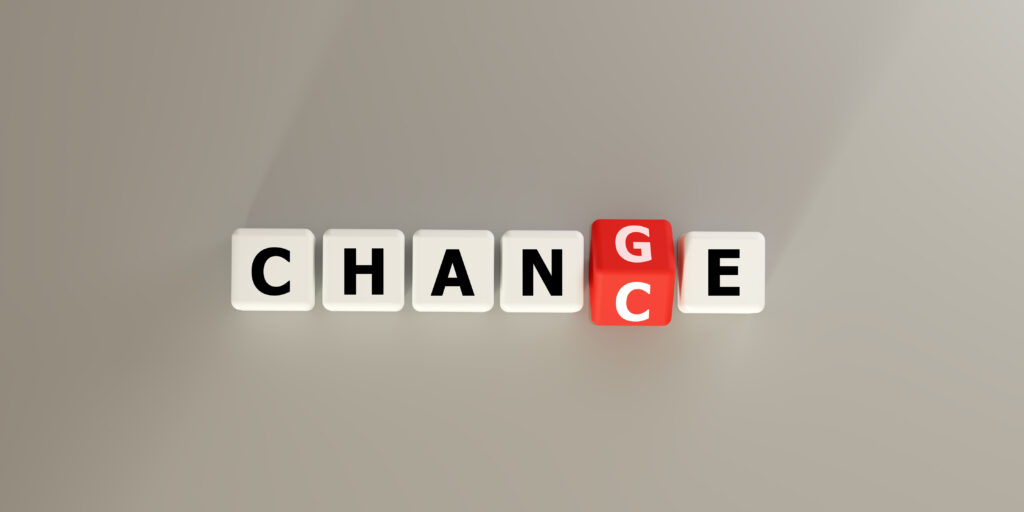 Blocks spelling CHANGE with a red letter block. Symbolizes transformation, transition, and evolution in business and life. Ideal for concepts of adaptation, growth, new beginnings, future direction.