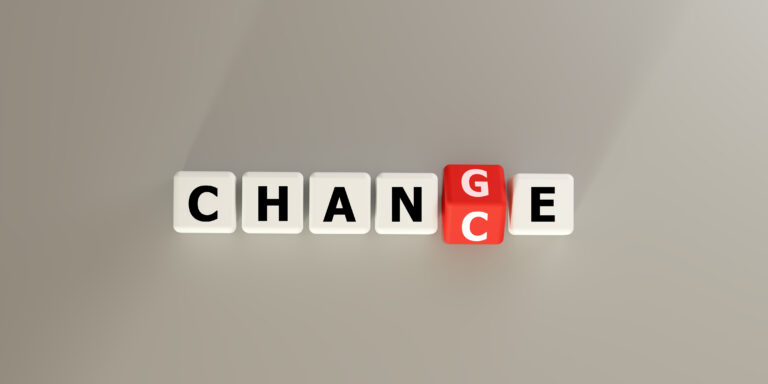 Blocks spelling CHANGE with a red letter block. Symbolizes transformation, transition, and evolution in business and life. Ideal for concepts of adaptation, growth, new beginnings, future direction.