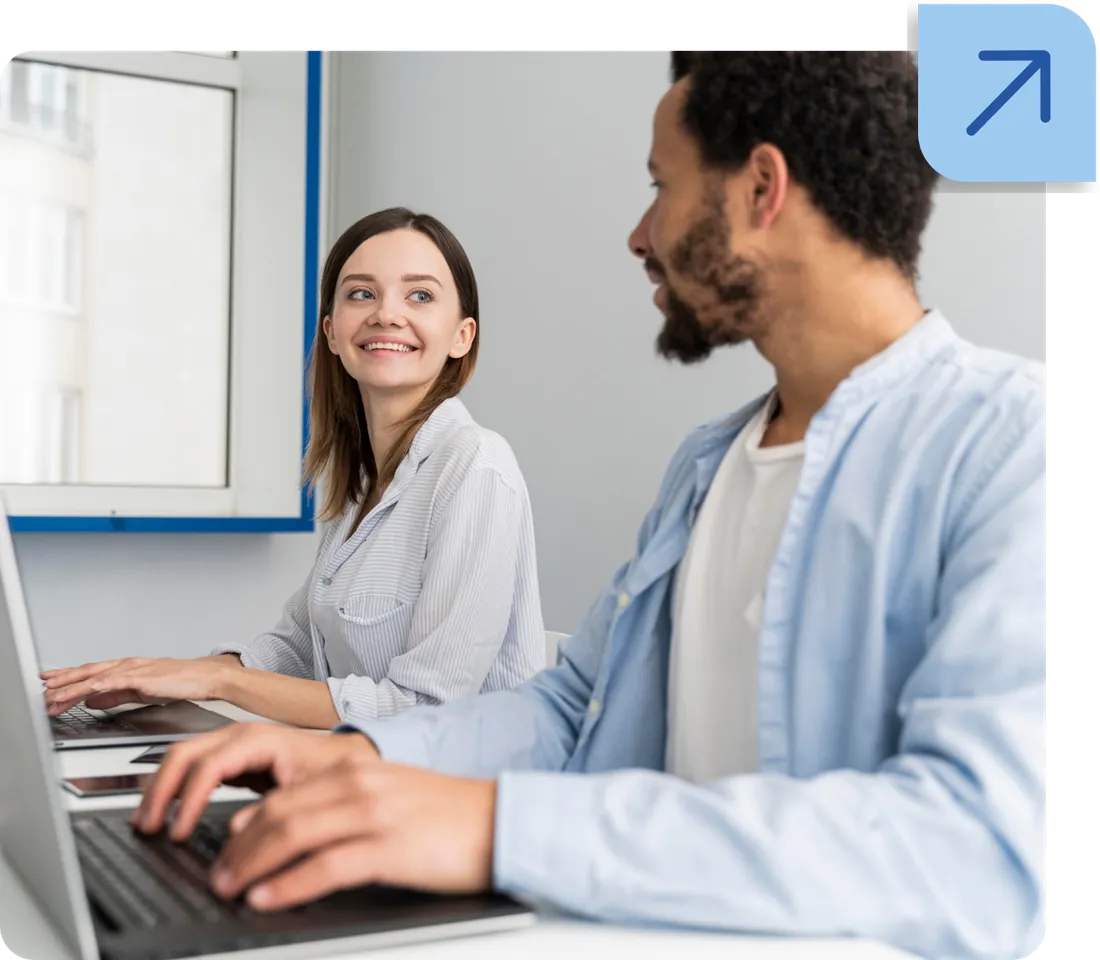 Two professionals collaborating at a laptop